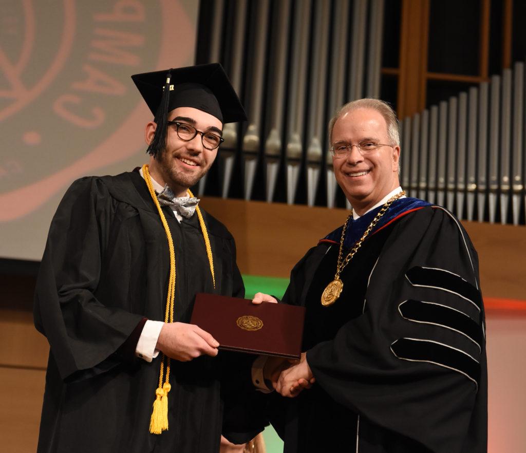 Dalton Bennett of Campbellsville receives his degree at last year’s December 2017 commencement from Dr. Michael V. Carter, president. (Campbellsville University Photo by Joshua Williams)