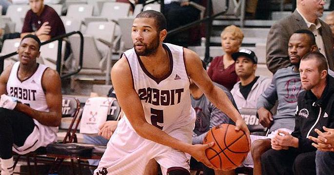 Darius Clement playing basketball during a game.