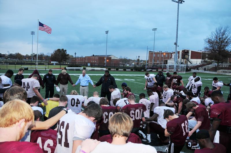 Members of the Campbellsville University Fighting Tigers Football Team said a prayer after receiving their "Life Books" from the Gideons and the CU Big Maroon Club. (Campbellsville University Photo by Ye Wei "Vicky")